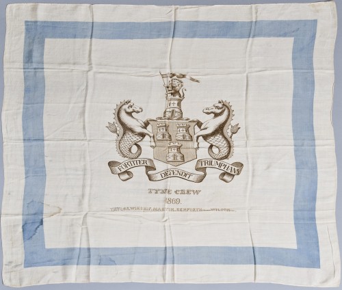 Rowing Colour of the Tyne Champion Four 1869. This colour was issued to mark the home and home races of the Tyne Crew, against a London crew, in the autumn of 1869. It features the Newcastle coat of arms and lists the Tyne Crew, (James) Taylor, (Thomas) Winship, (John) Martin, (James) Renforth (Stroke), (Thomas) Wilson (cox). The Tyne men won both races with the boy coxswain Wilson distinguishing himself on each occasion. TWCMS : 2011.3448. Discovery Museum